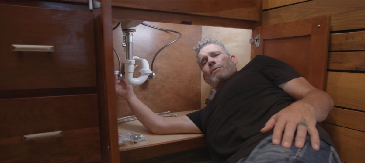 Licensed plumber diagnosing a residential plumbing issue in Jamestown, NY